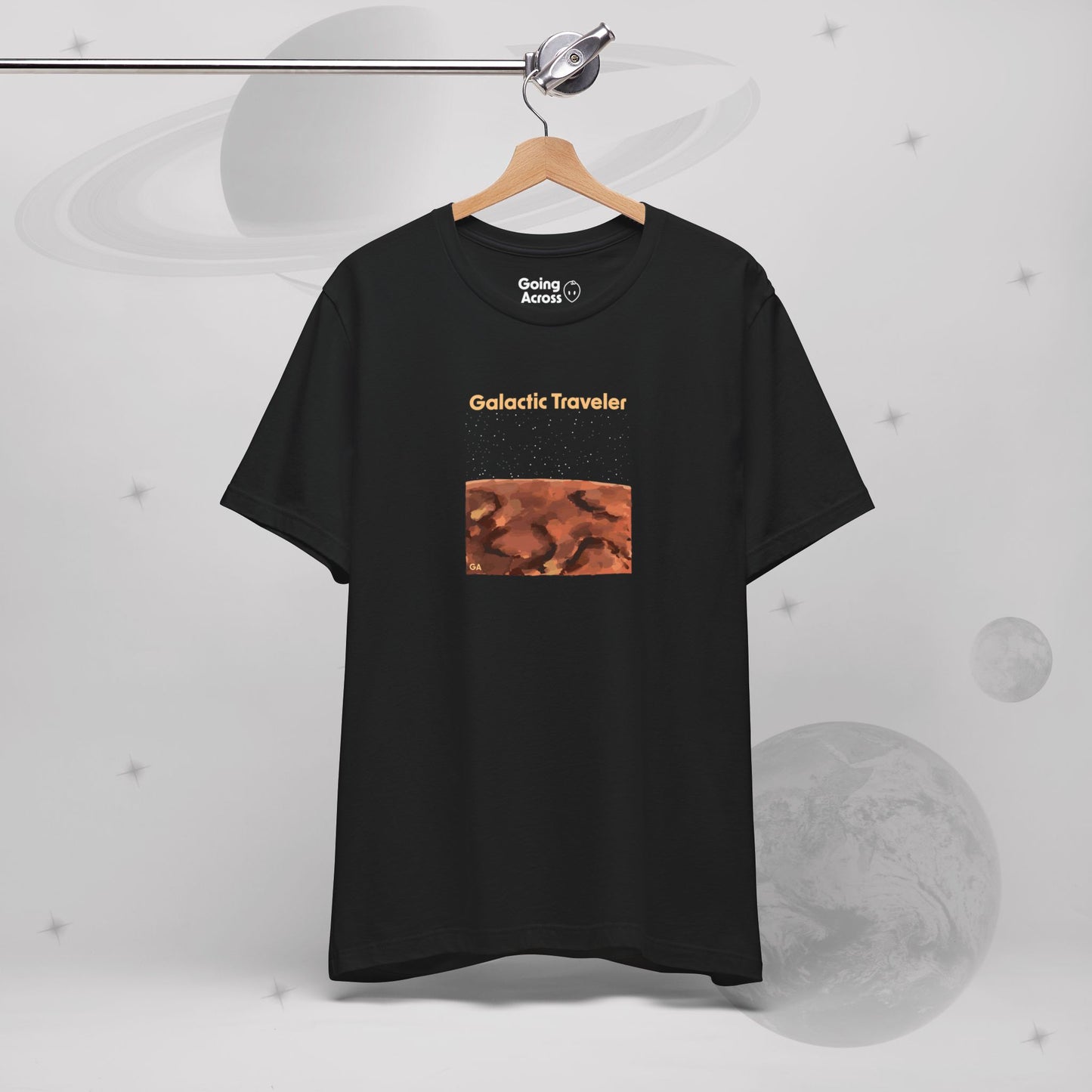 Going Across men's basic t-shirt in black, hanging, featuring the text ‘Galactic Traveler’ and space art of a red planet and a starry sky by Manharleen.