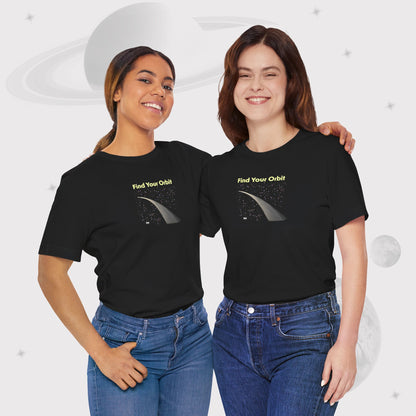 Two women wearing Going Across women's basic t-shirt in black with blue jeans, featuring the text ‘Find Your Orbit’ with space art of an orbit and a starry sky by Manharleen.