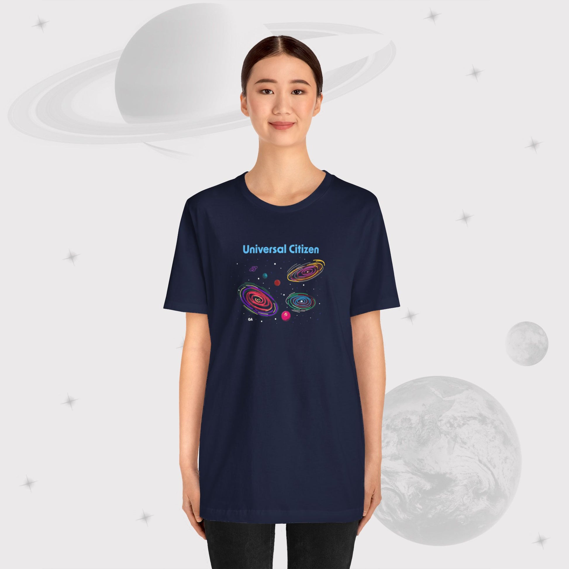 Girl wearing Going Across women's basic t-shirt in navy, featuring the text ‘Universal Citizen’ with space art of vibrant galaxies and planets by Manharleen.