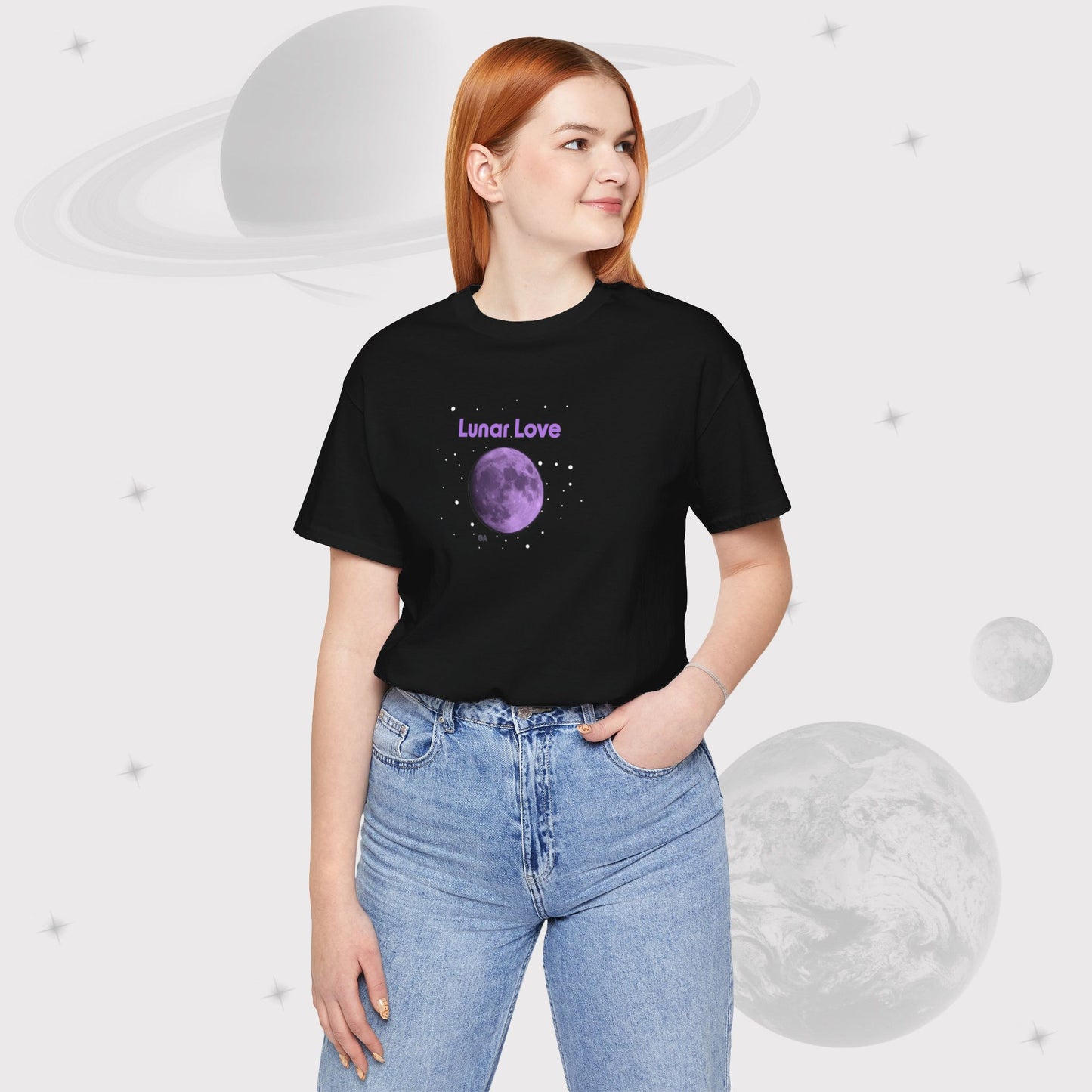 Woman wearing Going Across women's basic t-shirt in black with high waist jeans, featuring the text ‘Lunar Love’ with space art of purple lavender full moon by Manharleen.