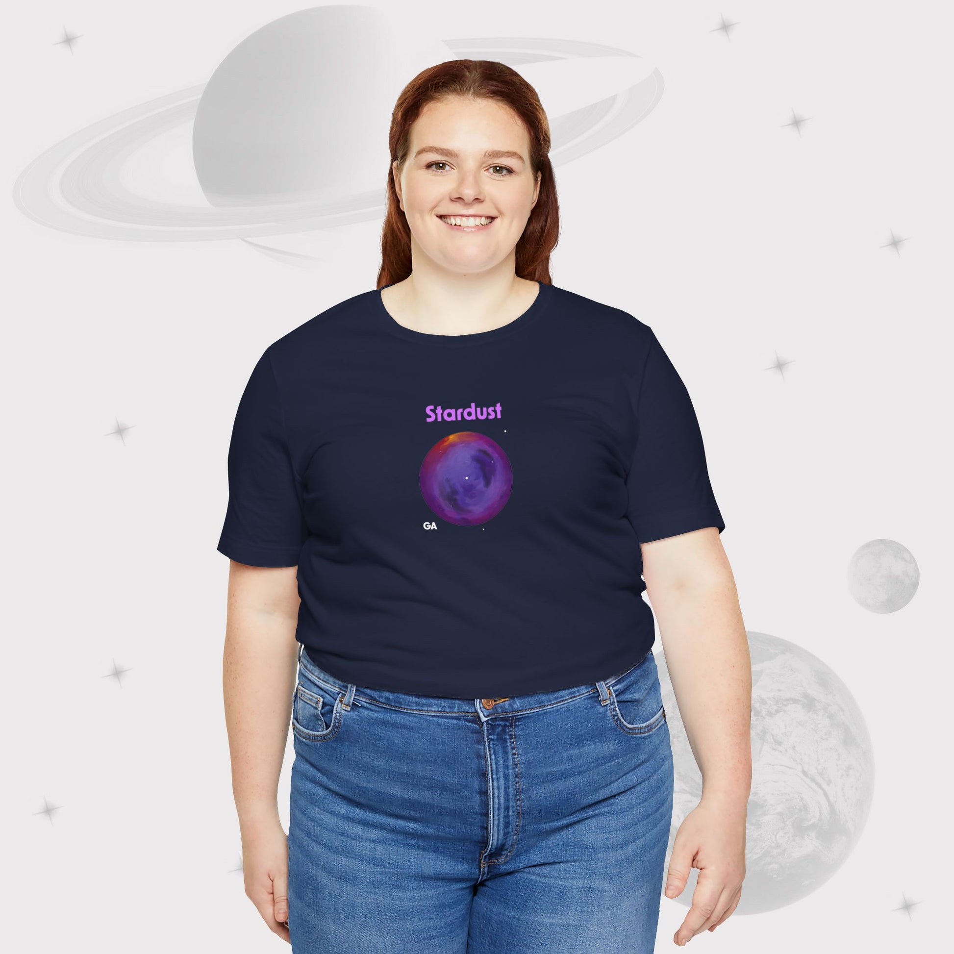 Plus Size Woman wearing Going Across women's basic t-shirt in navy with high waist jeans, featuring the text ‘Stardust’ with space art of bright purple nebula by Manharleen.