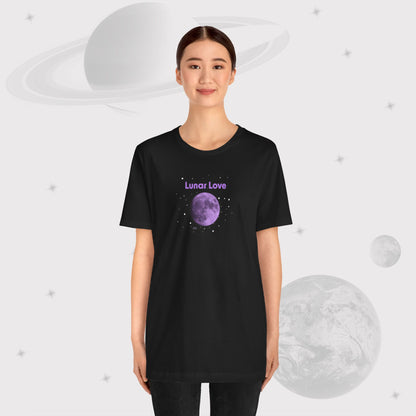 Woman wearing Going Across women's basic t-shirt in black with pants, featuring the text ‘Lunar Love’ with space art of purple lavender full moon by Manharleen.