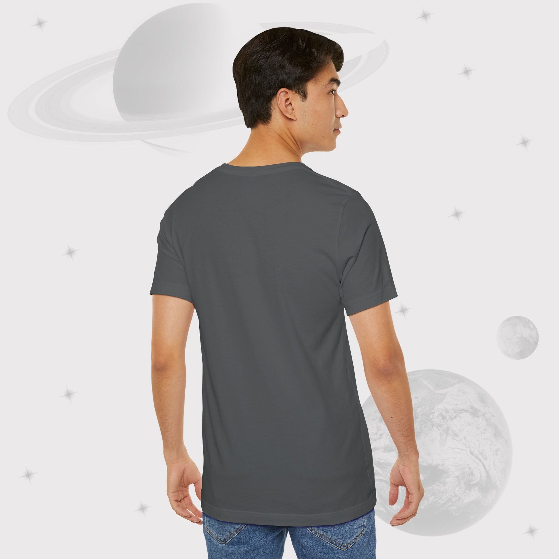 Back view of Man wearing Going Across men's basic t-shirt in asphalt/gray, featuring the text ‘Universal Citizen’ with space art of vibrant galaxies and planets by Manharleen.