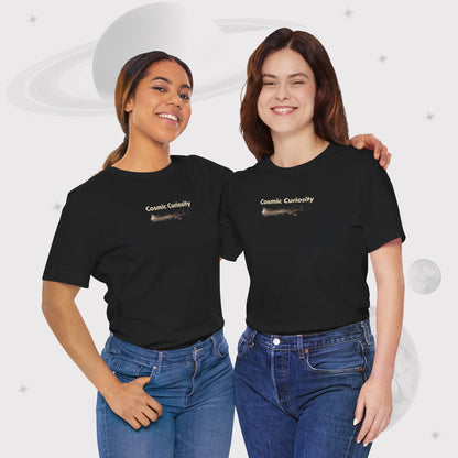 Two women wearing Going Across women's basic t-shirt in black with jeans, featuring the text ‘Cosmic Curiosity’ with space art of shooting stars by Manharleen.