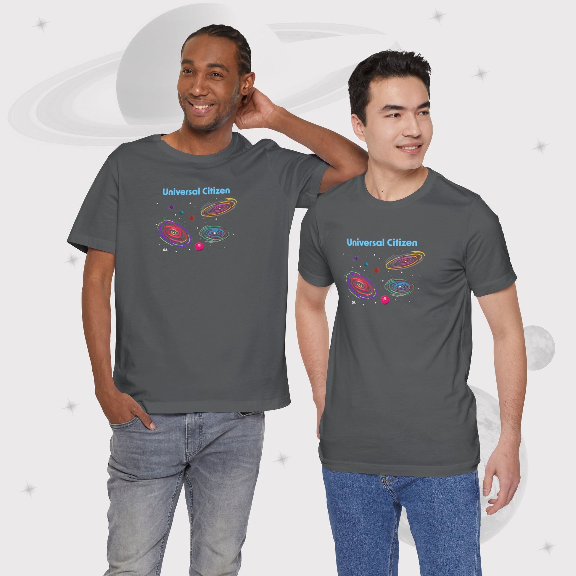 Two men wearing Going Across men's basic t-shirt in asphalt/gray, featuring the text ‘Universal Citizen’ with space art of vibrant galaxies and planets by Manharleen.