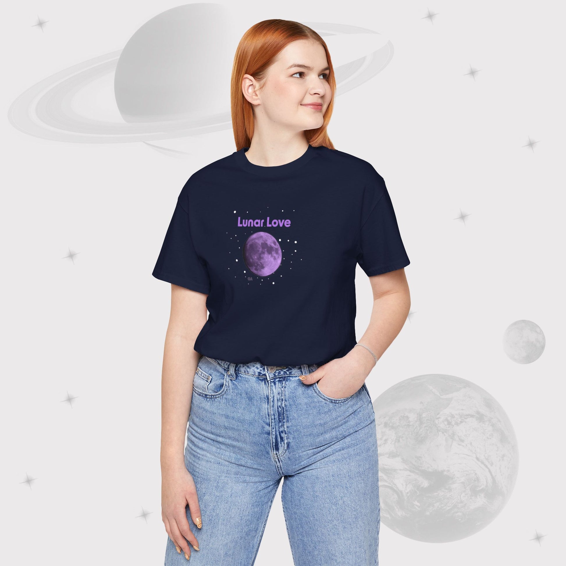 Woman wearing Going Across women's basic t-shirt in navy with high waist jeans, featuring the text ‘Lunar Love’ with space art of purple lavender full moon by Manharleen.