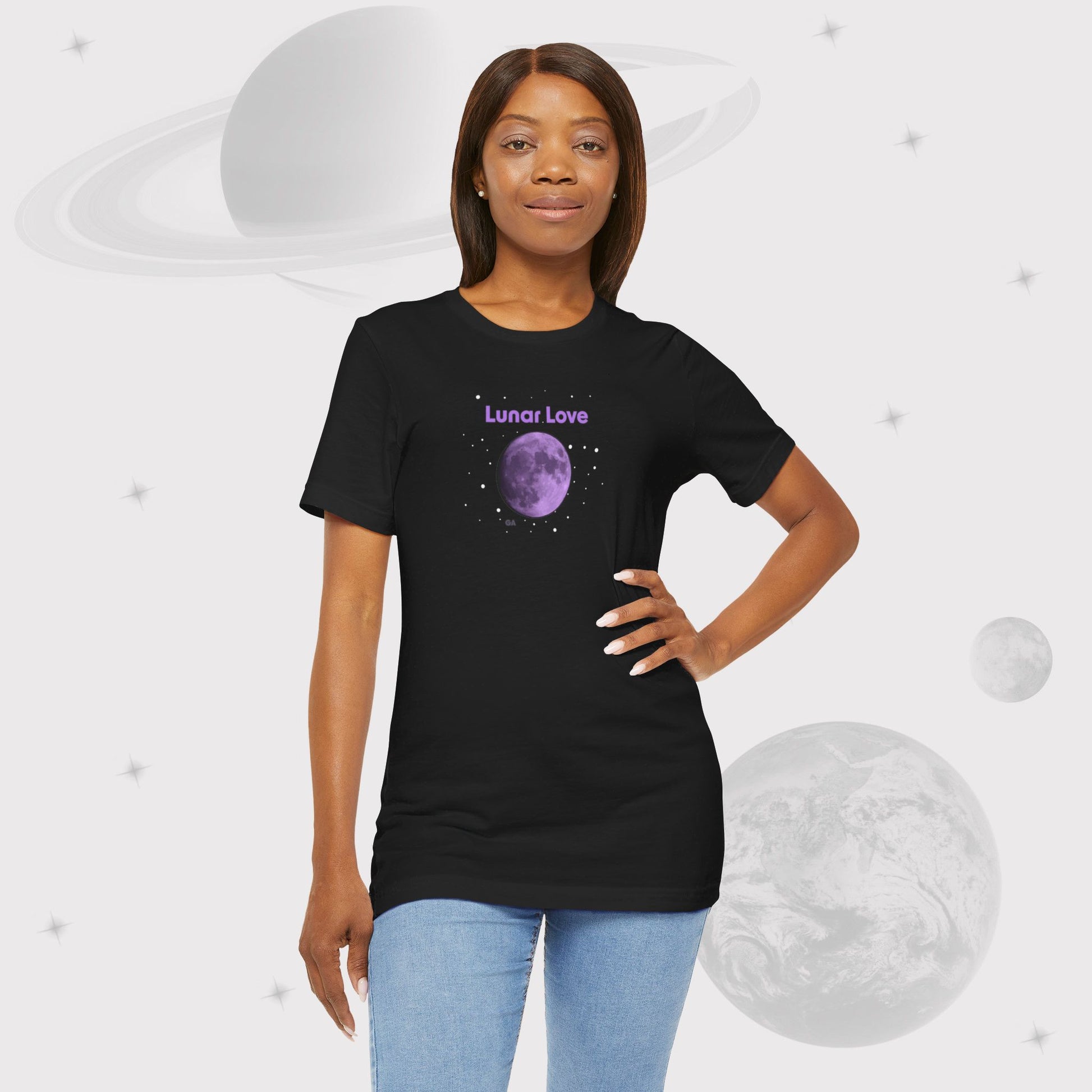 Woman wearing Going Across women's basic t-shirt in black with leggings, featuring the text ‘Lunar Love’ with space art of purple lavender full moon by Manharleen.