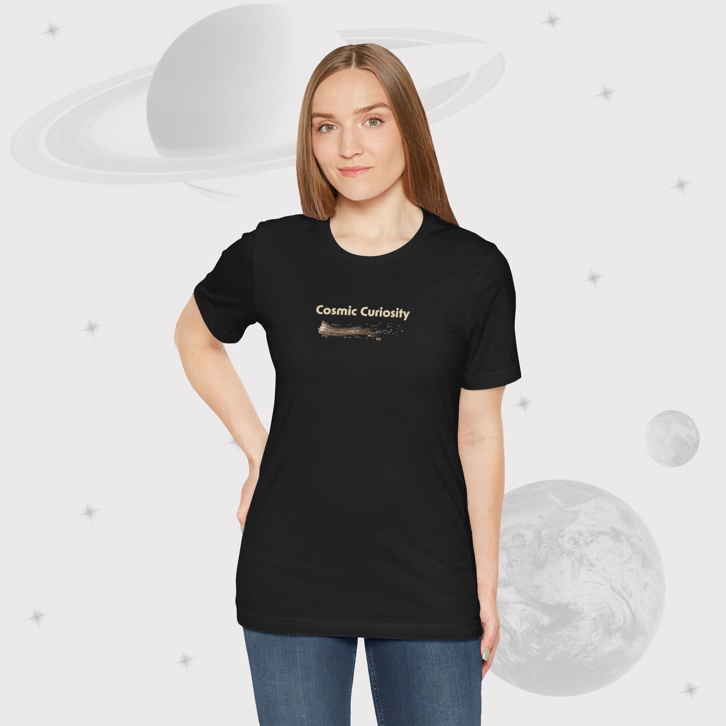 Woman wearing Going Across women's basic t-shirt in black with jeans, featuring the text ‘Cosmic Curiosity’ with space art of shooting stars by Manharleen.