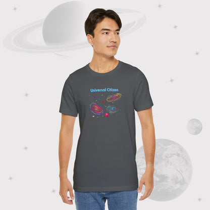 Guy wearing Going Across men's basic t-shirt in asphalt/gray, featuring the text ‘Universal Citizen’ with space art of vibrant galaxies and planets by Manharleen.