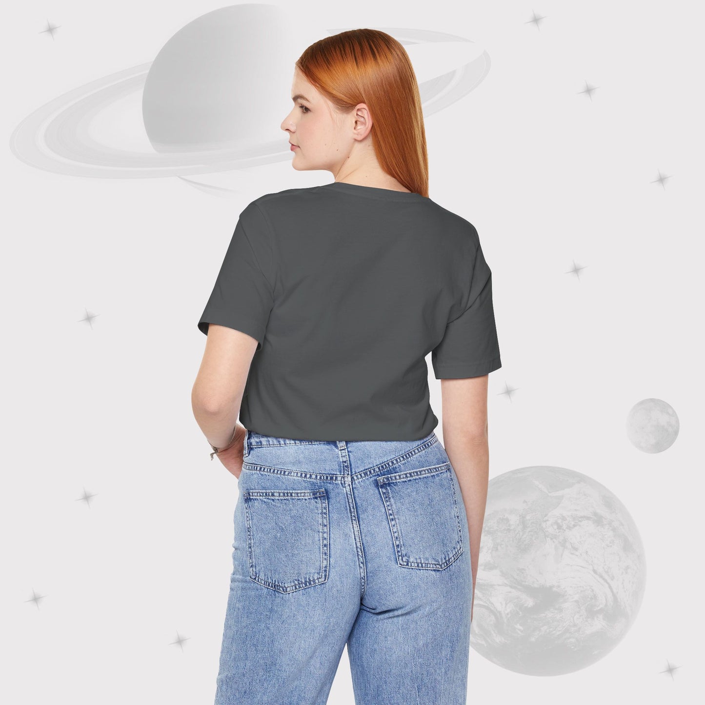 Back view of Woman wearing Going Across women's basic t-shirt in asphalt/gray, featuring the text ‘Universal Citizen’ with space art of vibrant galaxies and planets by Manharleen.