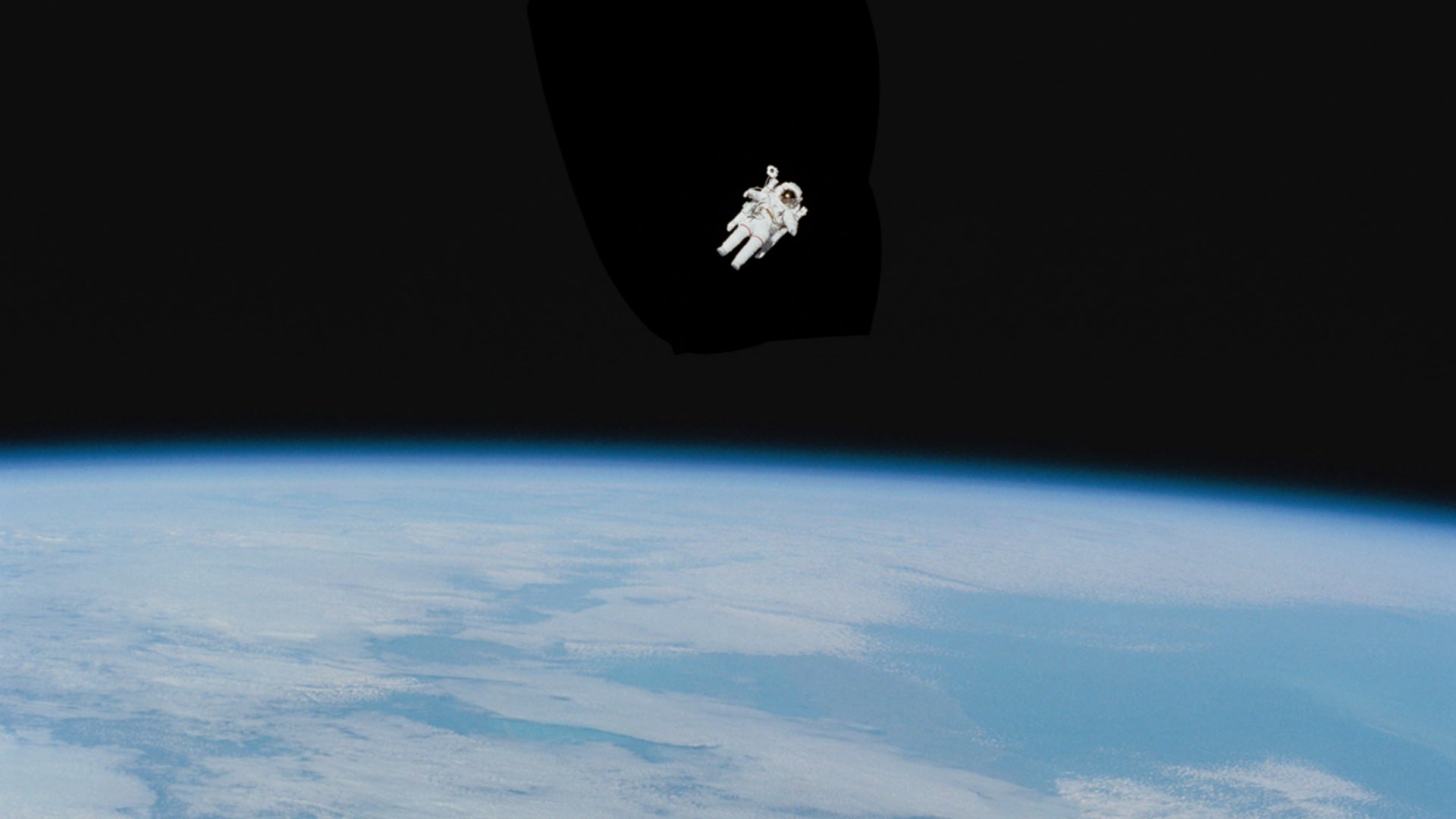 Astronaut floating in space with Earth in the background, capturing the spirit of exploration and adventure in 'Going Across' space-themed clothing.