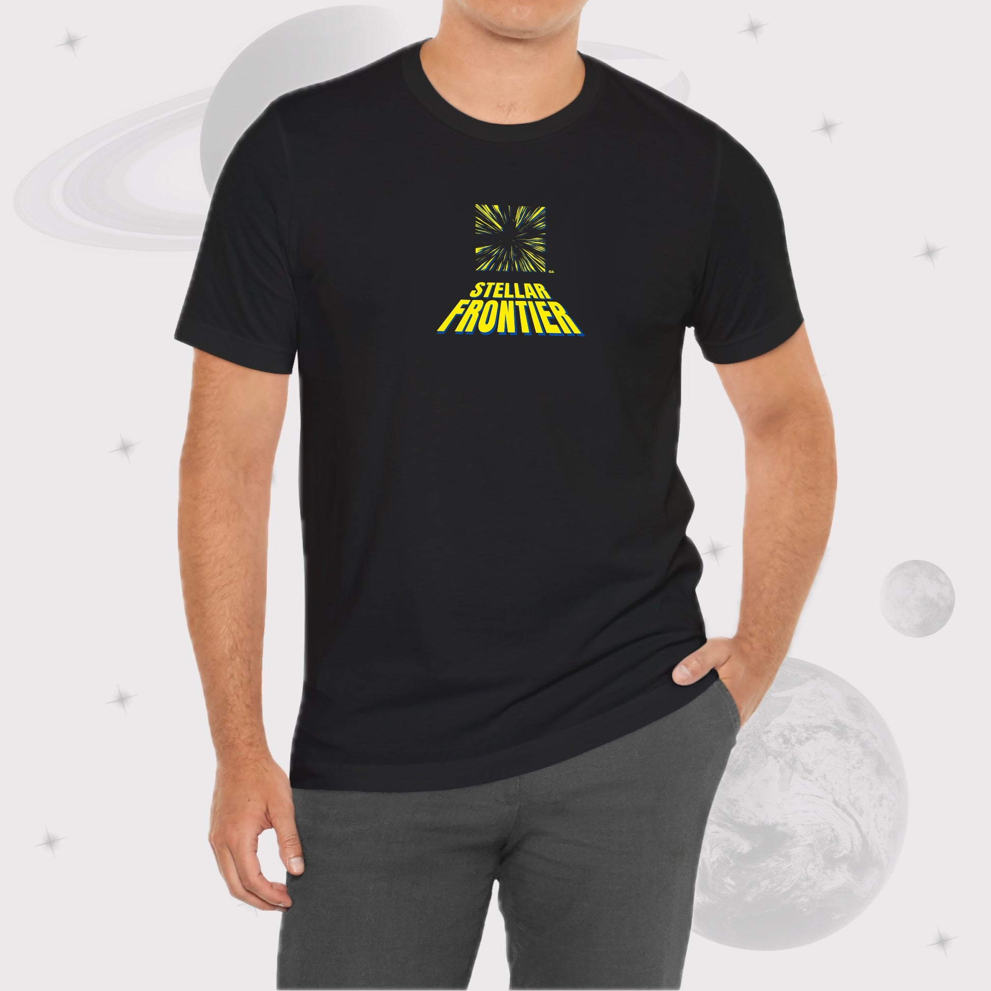 Man wearing Going Across men's basic t-shirt in black, with jeans, featuring the text ‘Stellar Frontier’ and vibrant yellow, deep blue space art by Manharleen.