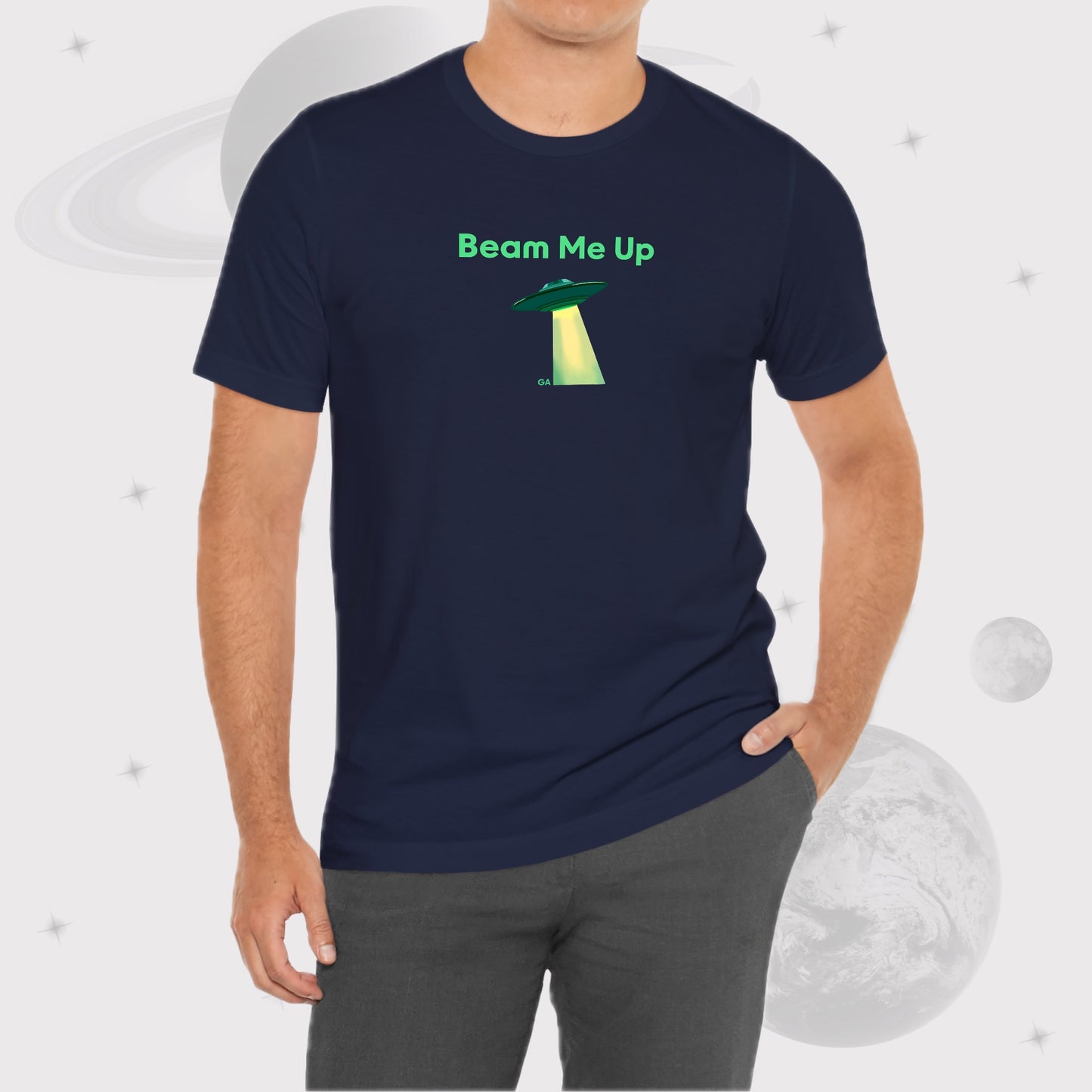 Man wearing Going Across men's basic t-shirt in navy, with jeans, featuring the text ‘Beam Me Up’ and space art of ufo in celestial green by Manharleen.