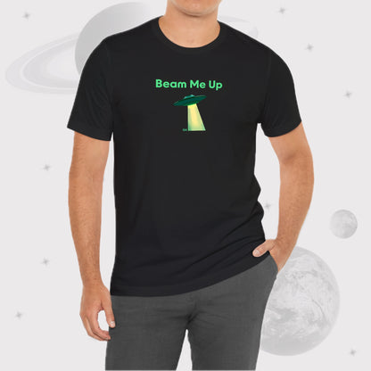 Man wearing Going Across men's basic t-shirt in black, with jeans, featuring the text ‘Beam Me Up’ and space art of ufo in celestial green