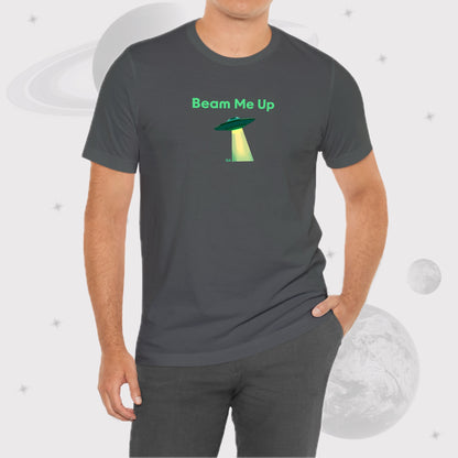 Man wearing Going Across men's basic t-shirt in asphalt, with jeans, featuring the text ‘Beam Me Up’ and space art of ufo in celestial green by Manharleen.