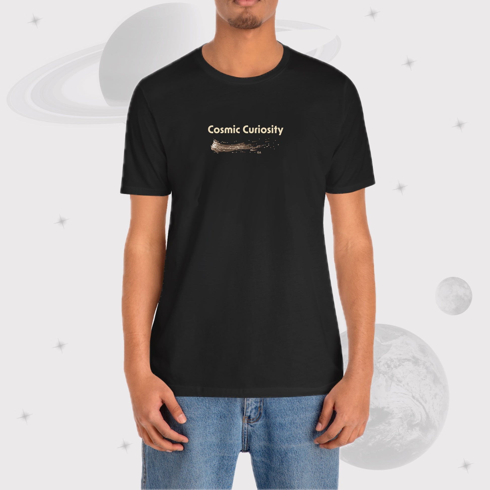 Man wearing Going Across men's basic t-shirt in black, featuring the text ‘Cosmic Curiosity’ with space art of shooting stars by Manharleen.