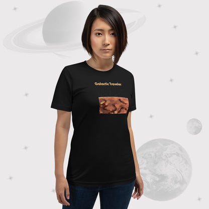 Woman wearing Going Across women's basic t-shirt in black with leggings, featuring the text ‘Galactic Traveler’ with space art of a red planet and a starry sky by Manharleen.