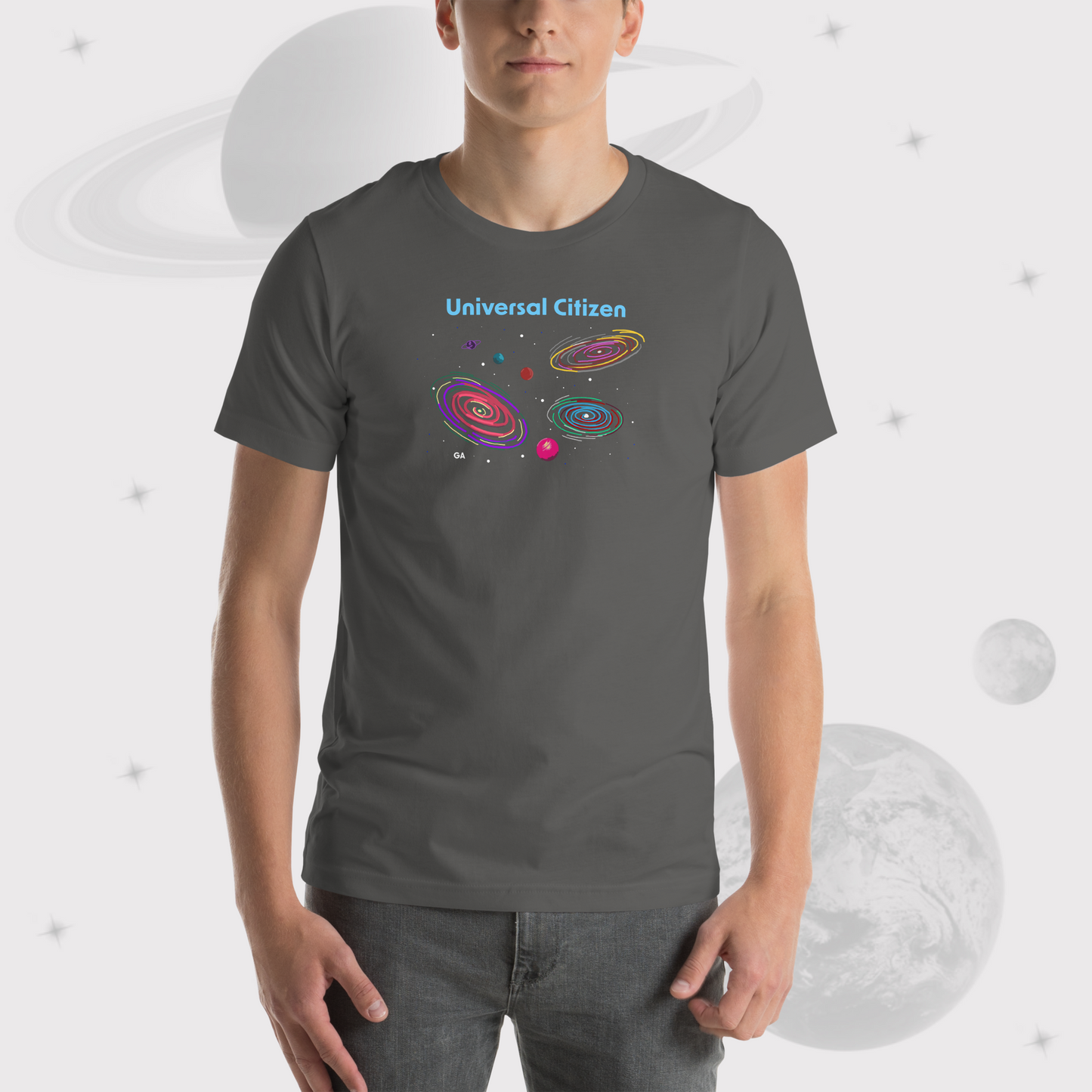 Zoom in of Man wearing Going Across men's basic t-shirt in asphalt/gray, featuring the text ‘Universal Citizen’ with space art of vibrant galaxies and planets by Manharleen.