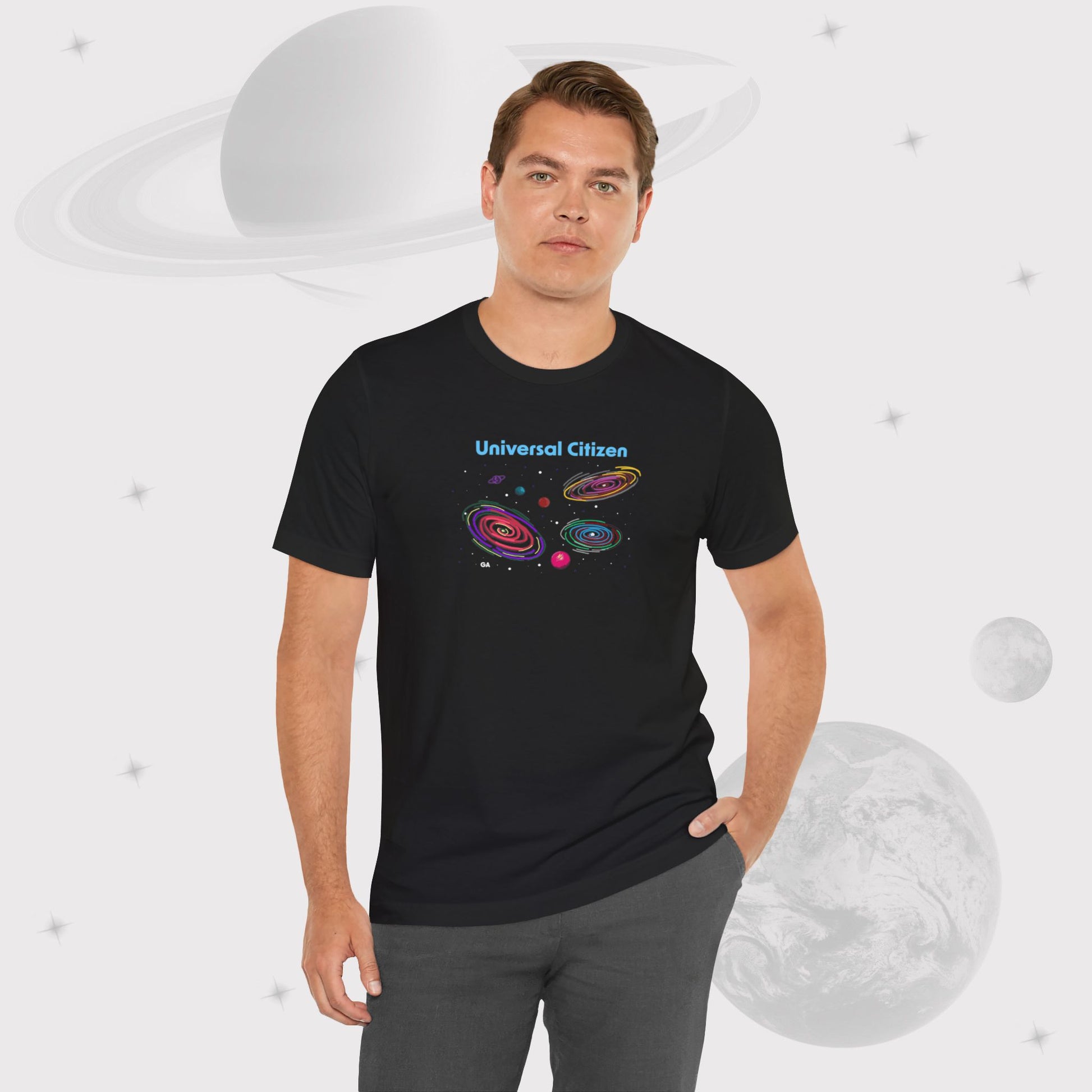 Man wearing Going Across men's basic t-shirt in black, wearing jeans, featuring the text ‘Universal Citizen’ with space art of vibrant galaxies and planets by Manharleen.